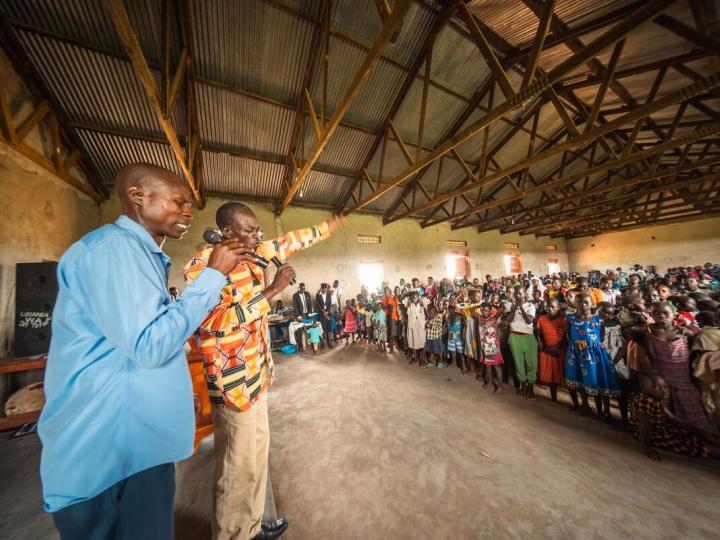 a group of people from Uganda praying