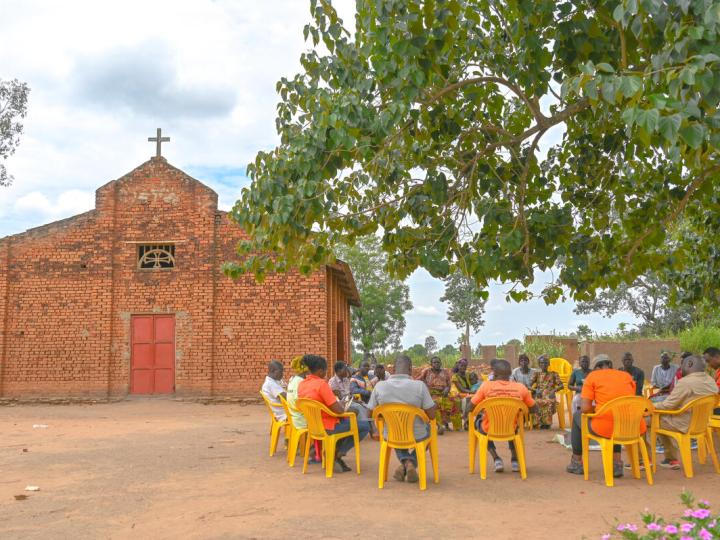 Farmer groups in a meeting with World Vision Staff Infront of the church