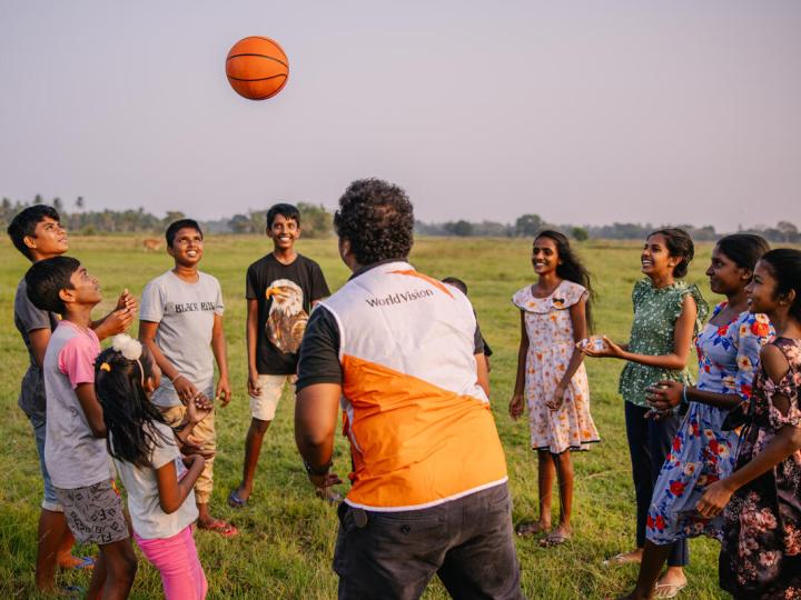 A World Vision staff playing with the children