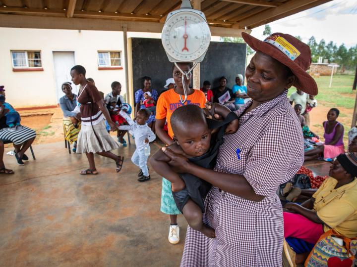 CHW Gertrude weighing baby
