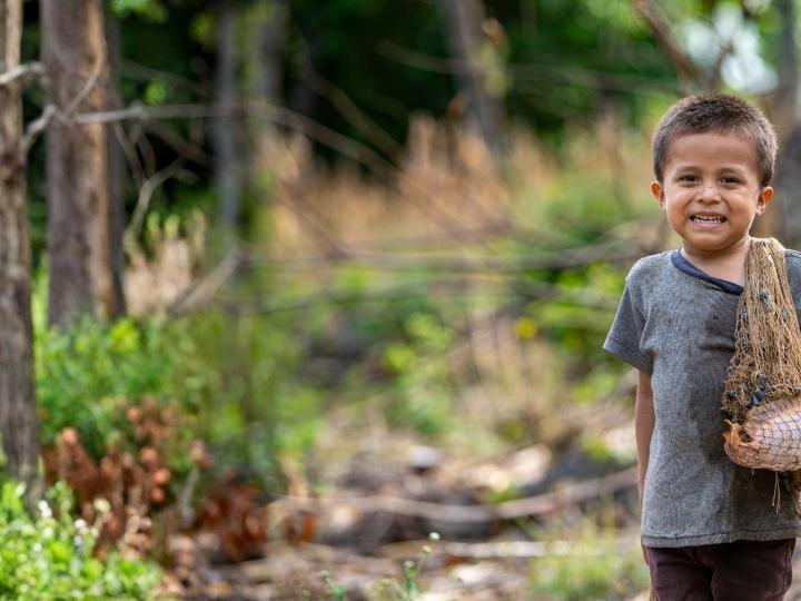 Child Smiles to the Camara