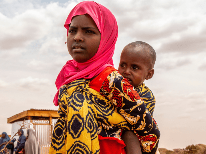 Child carrying her brother