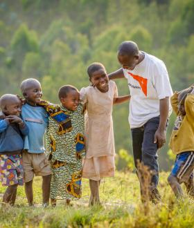 World Vision staff with 5 children