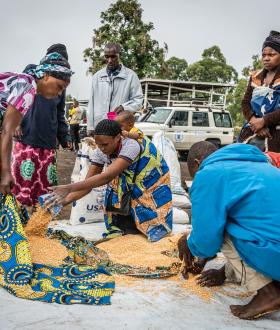 Internal displaced people sharing meal after a food distribution at Kanyaruchinya IDP camp