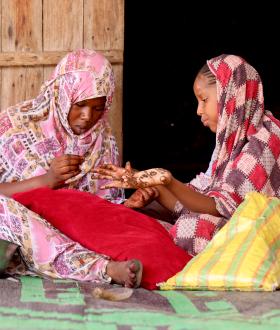 two young girls preparing themselves for Henna night