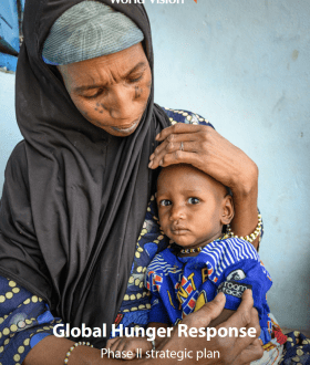 This is the cover page of the GHR Phase II strategic plan, featuring a mother cradling her child.