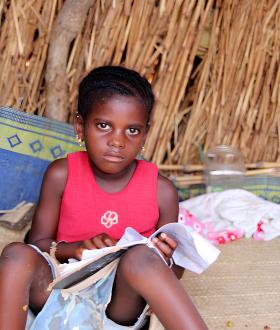  In Djenné Cercle, Mali, Hawa, a displaced child, reads from her notebook.