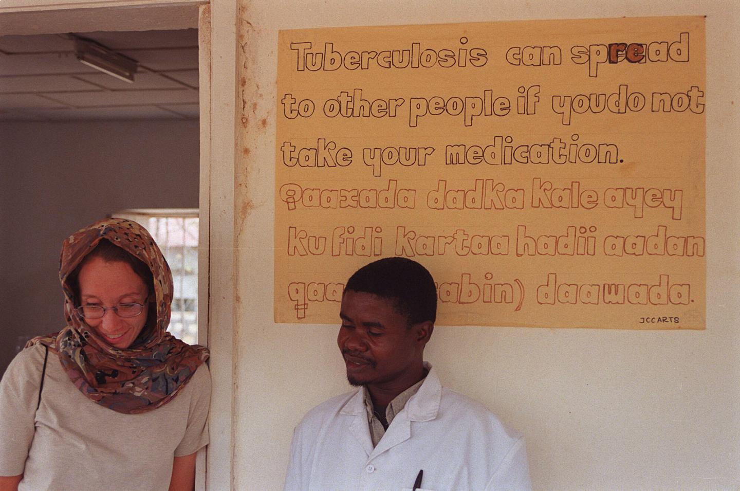Ashley standing with a WV Somalia Staff 