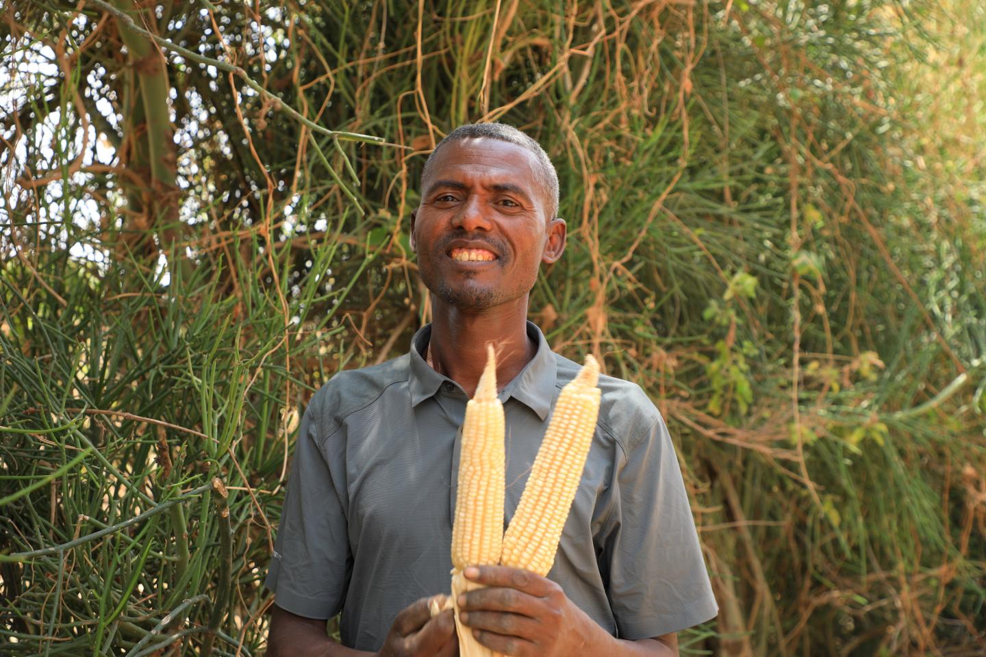 Basero holding corn and smiling