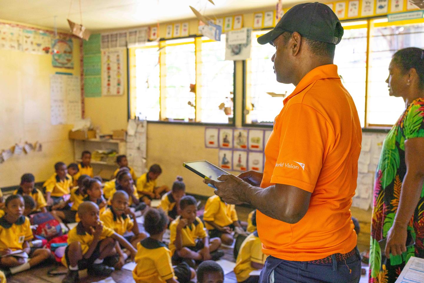 World Vision Officer under PIE Project doing lesson assessment