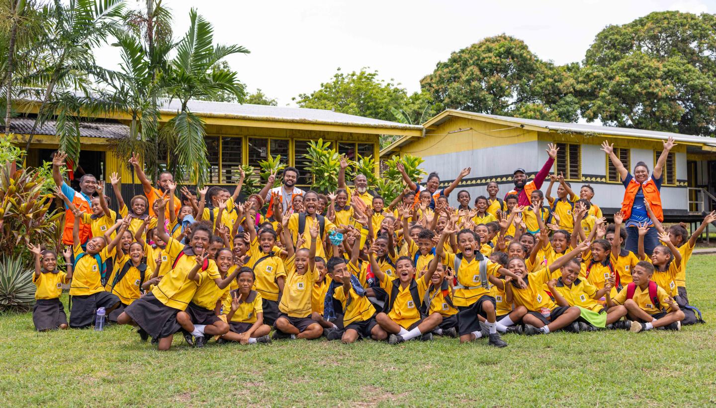 The students and teachers of Kupiano Elementary School with the PIE Team posing for a group photo