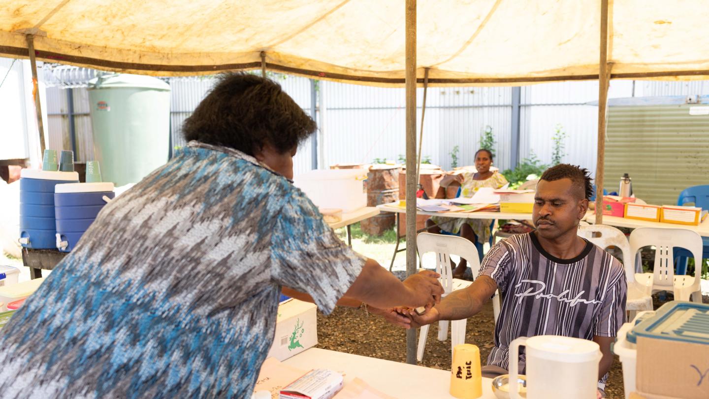 Treatment supporter attending to Ray for his treatment