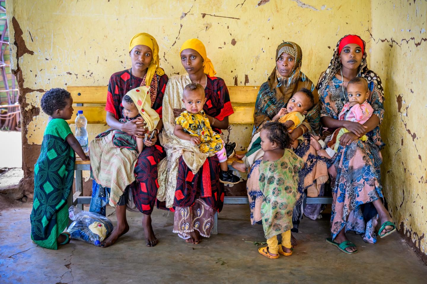 Mothers with malnourished children wait to be seen at a health center in Kortu / Ethiopia / 2025.