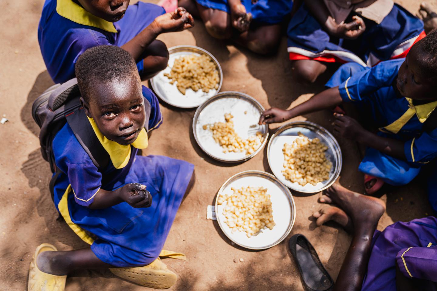 A young girl in Juba, Central Equatoria State, enjoying a nutritious school meal 