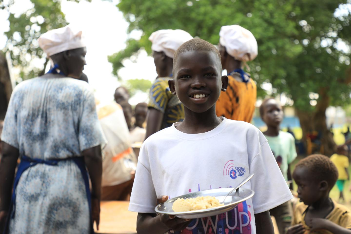 Gatwech recieving school meal at school