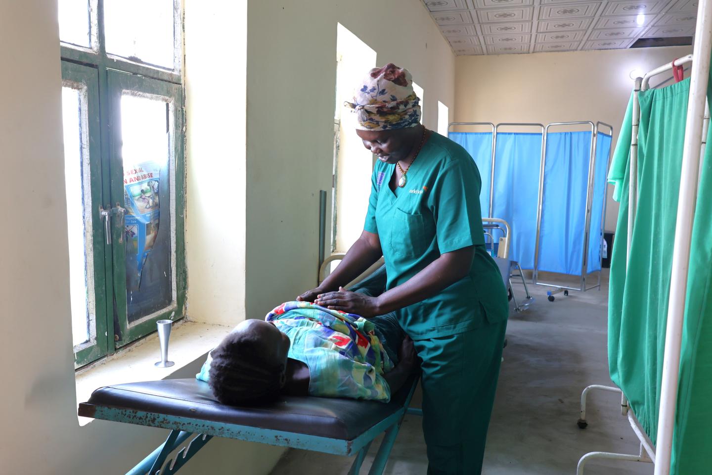 Rebecca performing a routinely check on an expectant mother 