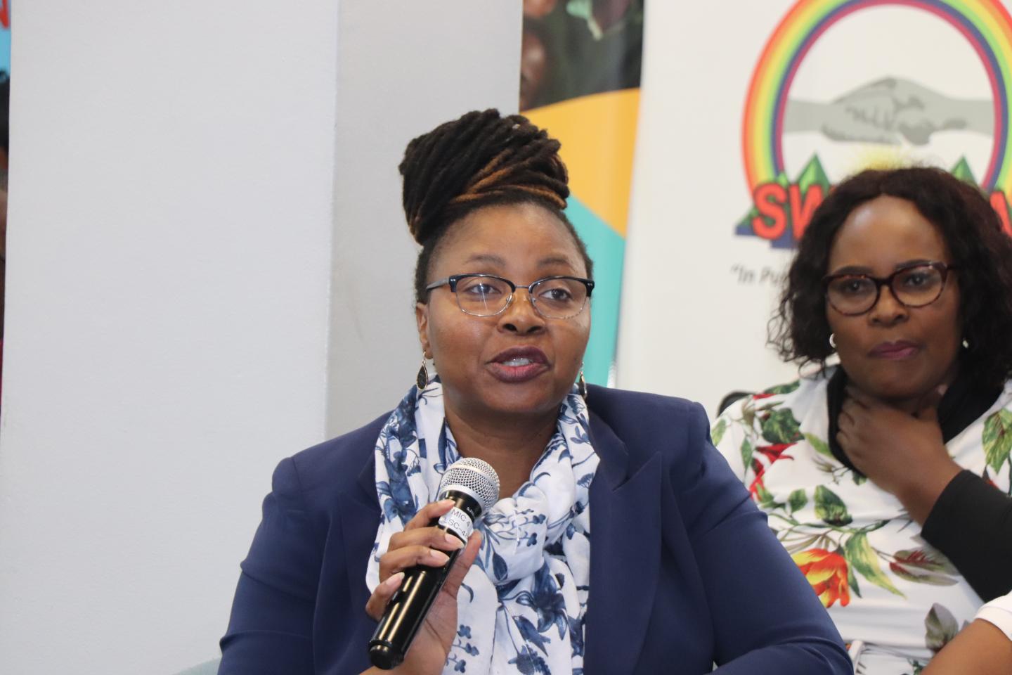 A woman holding a microphone.