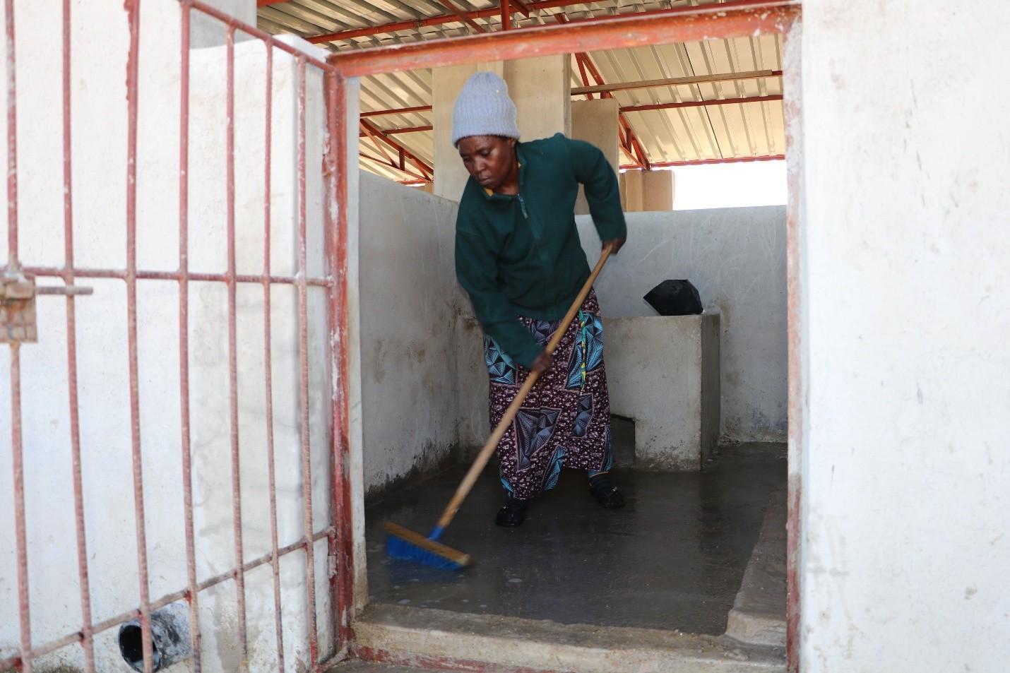 Jacque cleaning the pigsties