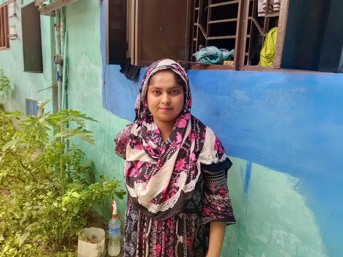 Chameli stands outside her home in Hafiznagar, Khulna.