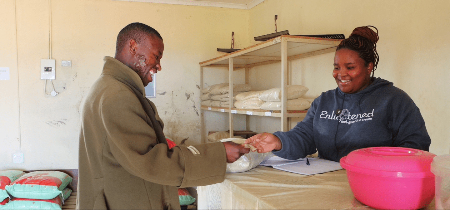 Two people inside a shop during transaction.