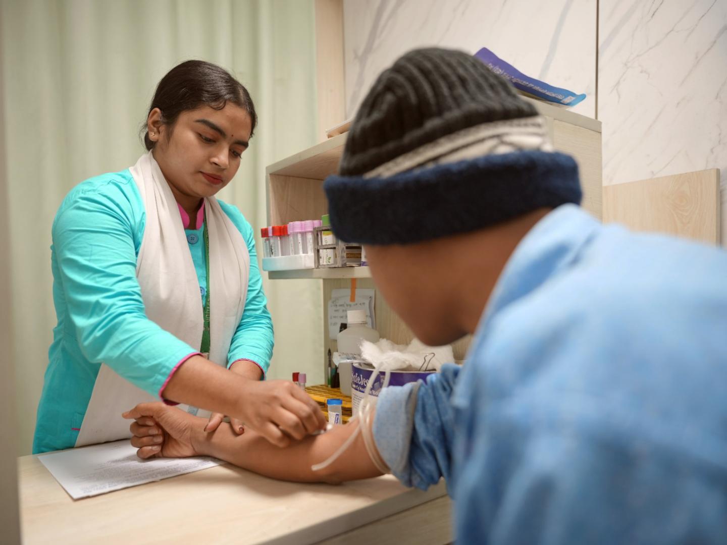 Bhavna, a pathology intern, collects a blood sample from a patient during her internship in the Blood Transfusion Department at a general hospital.