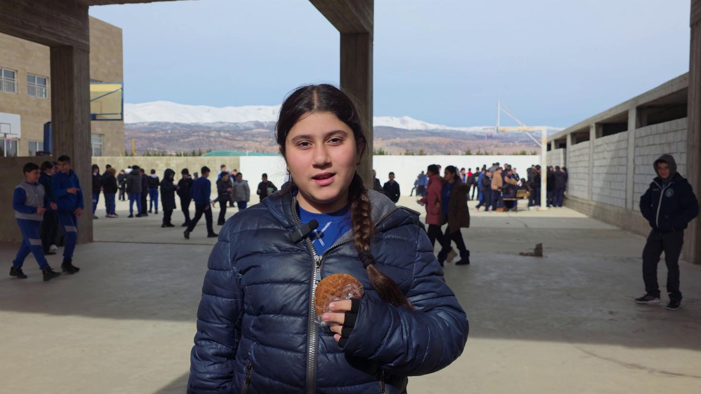 Benita, a Grade 6 student, holds one of the healthy snacks provided through World Vision's School Feeding Project.