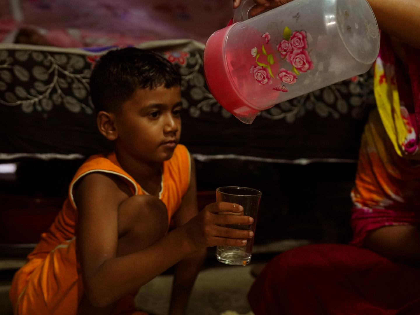 Imam asking for a glass of water to his mother