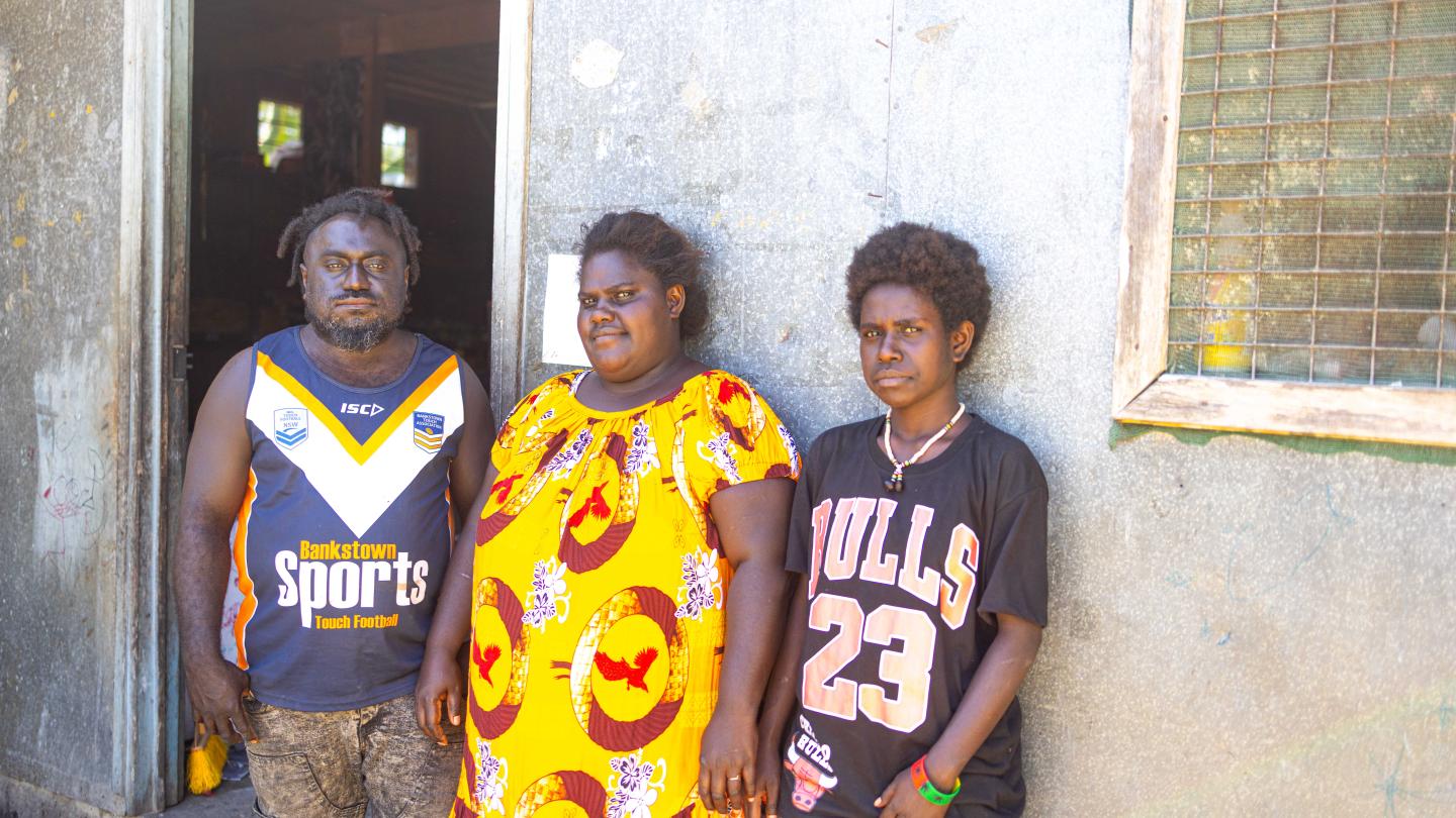 Amalanie pictured with husband and daughter in front of her SME store