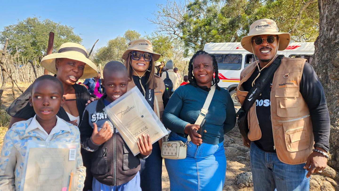 Bishop Shelby (far right) and his wife Bonita (in glasses) pose for a photo with some of the children and their guardians