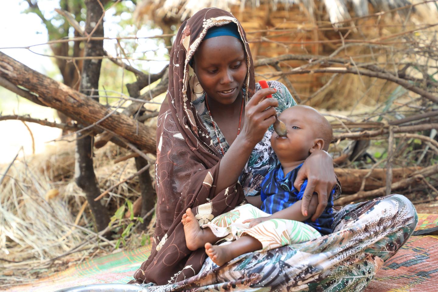Timira feeing her son Muaris