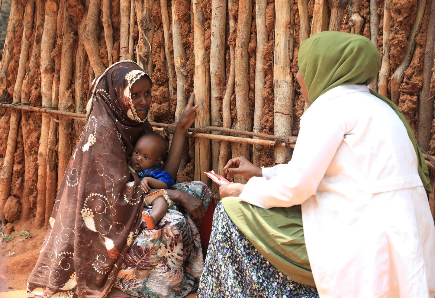 Timira getting consultation form a health worker