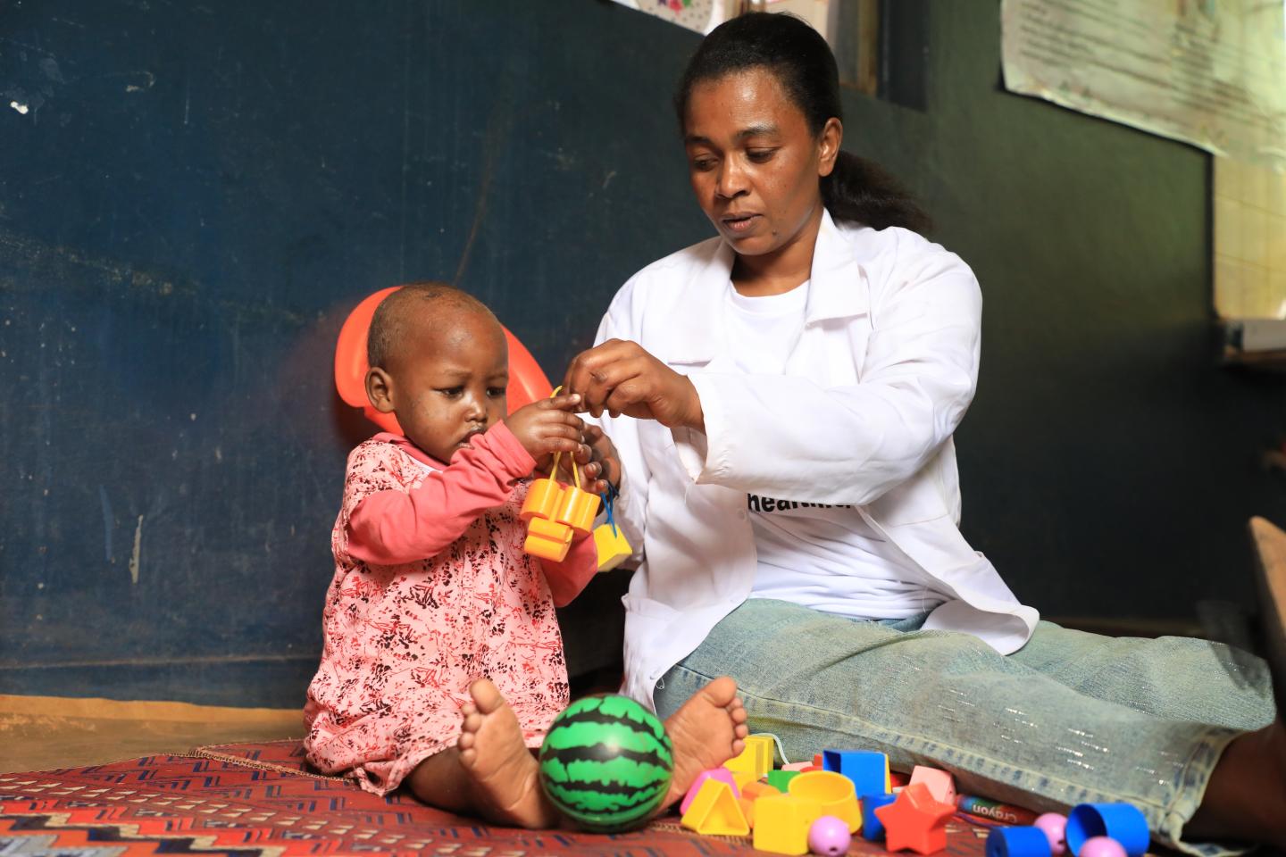 Health care officer playing with Efrahe