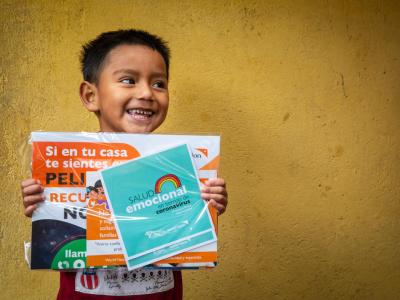 Boy in Ecuador with educational materials