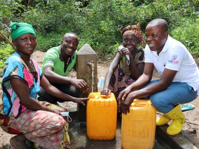 Norbert shows us a potable water source installed in his village