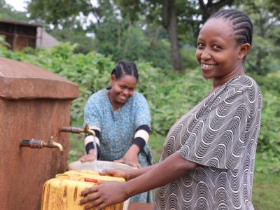 Woman getting water from tap