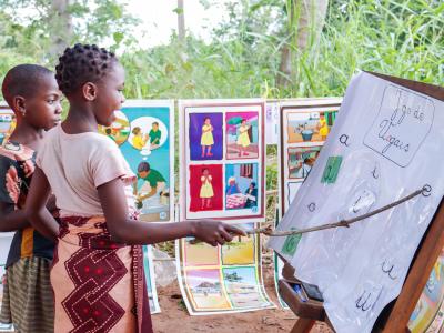 Children perform vowel exercise to improve literacy abilities in Reading Camp