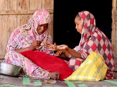 two young girls preparing themselves for Henna night