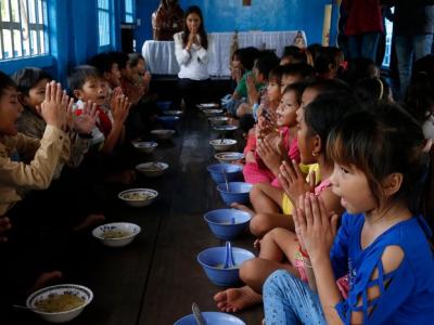 A meal served to children in Chong Khnies floating catholic church on the Tonle Sap lake, Cambodia.