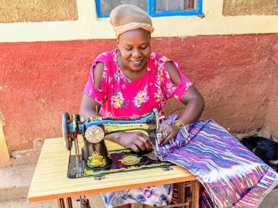 Jeneffer currently uses a manual sewing machine and hopes to buy an electric one to reduce the strain on her leg.  ©World Vision Photo/ Hellen Owuor