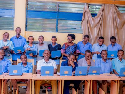 Nyamata Technical Secondary School students showcasing laptops given by World Vision