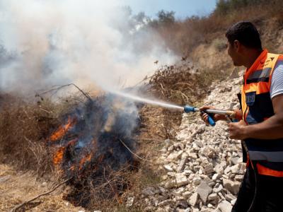 A local volunteer responds to a fire in the West Bank