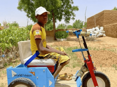 Jabirou is here proudly sitting on the tricycle bike received