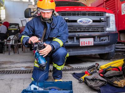 A Palestinian firefighter is trained to use new tools to respond to emergencies