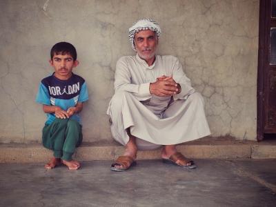 Mahran and his father at their home in Rashad. Ziryan Kameran© World Vision 