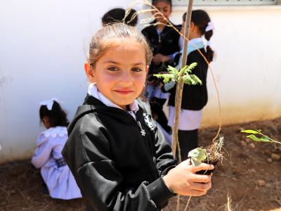 Palestinian girl planting a tree