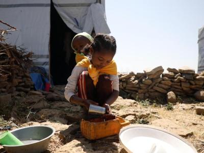 A little girl doing house chores