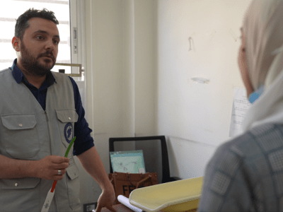 A photo of one of the specialised staff at the hospital providing support to a patient . 
