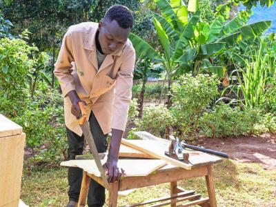 Nathan Kipyego is a youth lead farmer implementing FMNR in Elgeyo Marakwet County and has now turned his beekeeping skills into a source of income. ©World Vision Photo/ Hellen Owuor