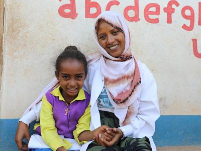 Kalkidan with her teacher smiling