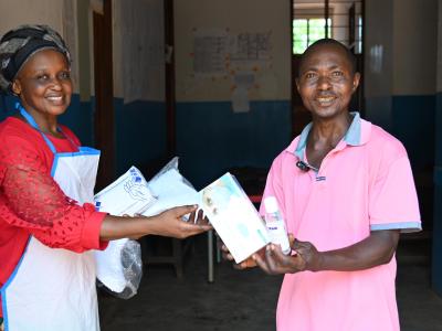 Mimi giving a Health community worker some items